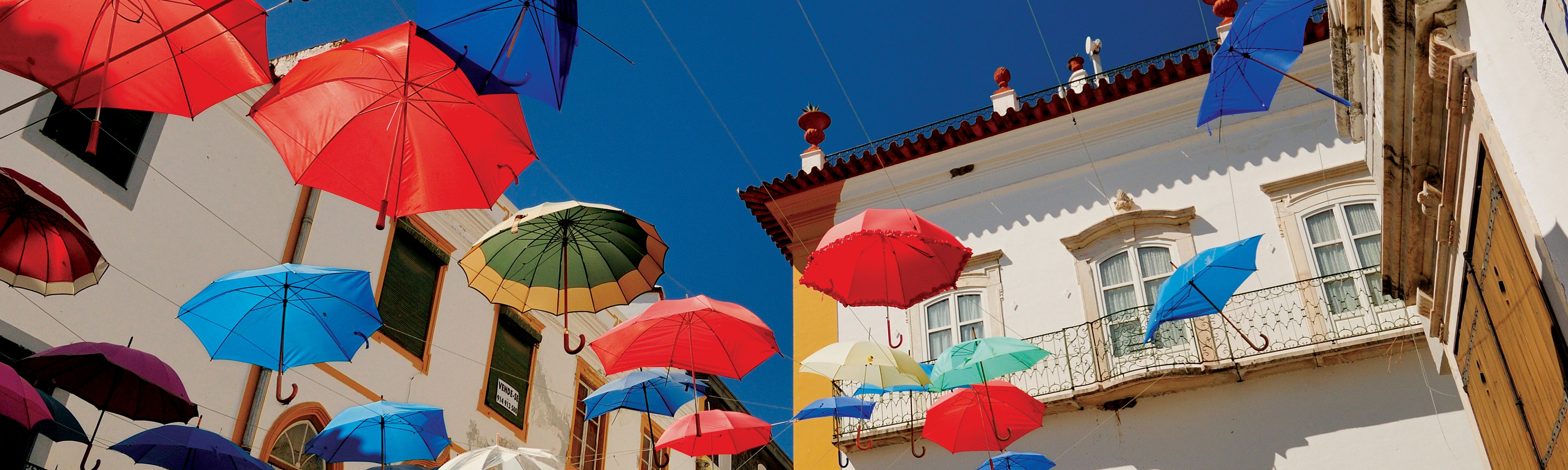 colorful umbrellas hung up in plaza in lisbon portugal