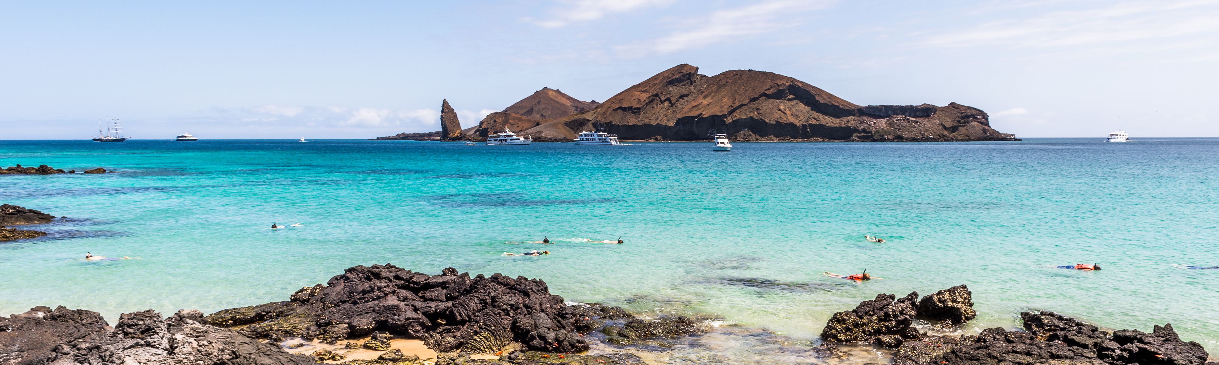 people snorkeling along the coast of the galapagos islands