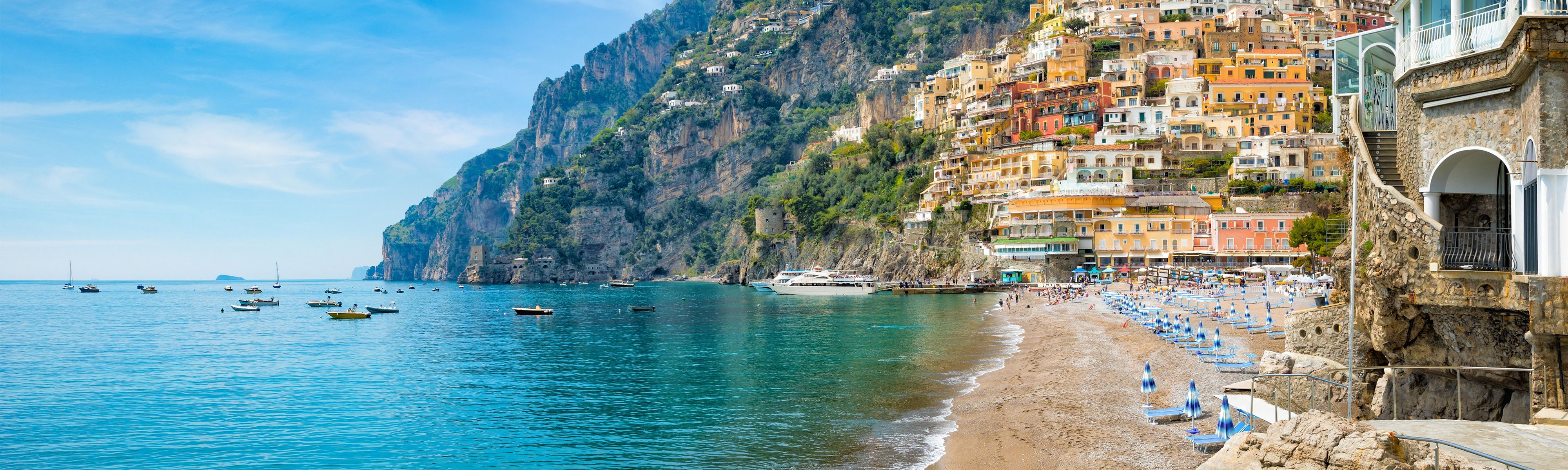 boats sitting in marina along the coast of the amalfi coast in italy