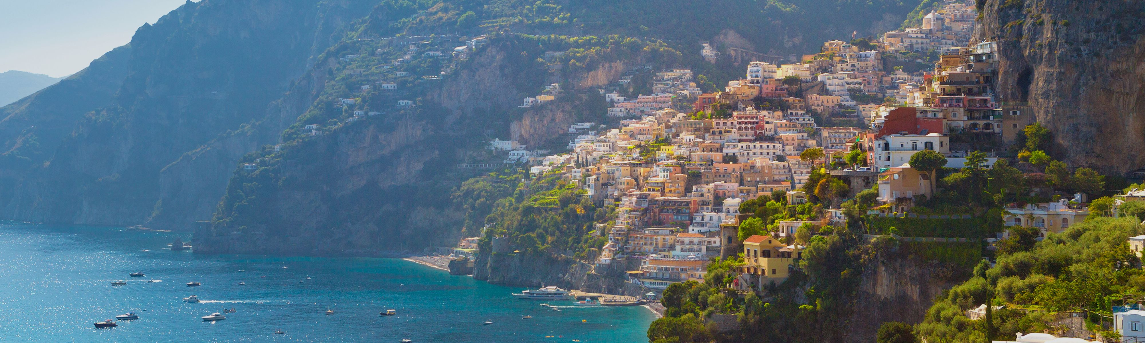 yellow and tan houses along the cliffs of the amalfi coast in italy