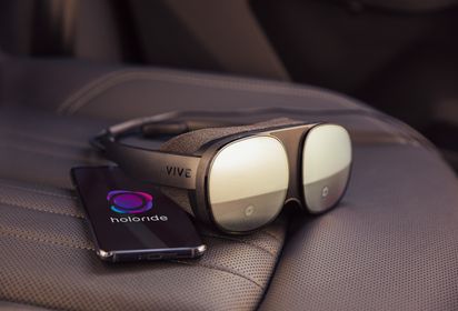 HTC Vive Flow headset with mobile phone laying on the backseat of the car