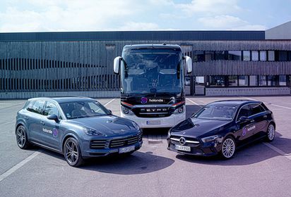 Porsche, Daimler and EvoBus vehicles standing on a parking lot