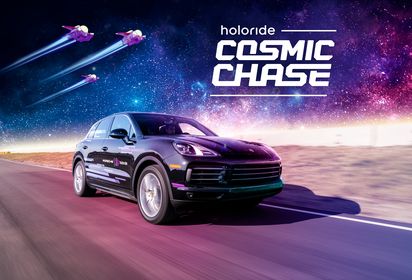 Porsche Cayenne with holoride branding, driving around and playing Cosmic Chase game