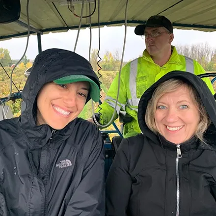 Two Welch's staff members touring a vineyard, smiling. 