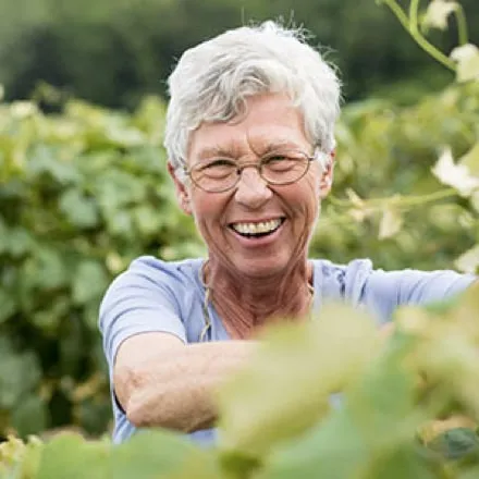 Portrait of a Welch's co-op farmer smiling in a vineyard