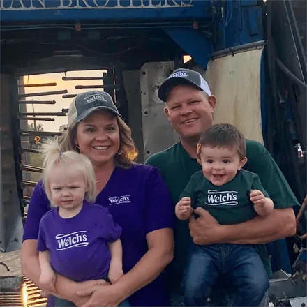 Paul Killian, Welch's Farmer, and his wife and two children, all wearing Welch's tees.