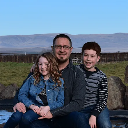 Todd Wheeler, Welch's Farmer, and his two children on their Concord Grape farm. 