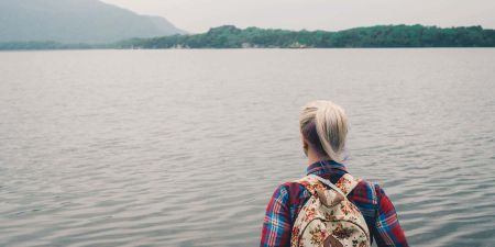 Girl gazing out over a lake in Ireland