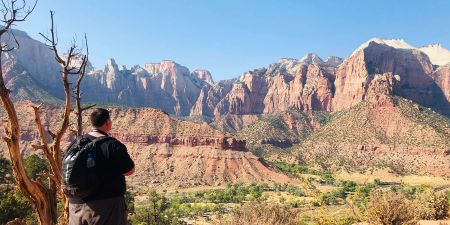 A traveler gazes out over Zion National Park in Utah.