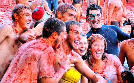 People covered in tomato sauce at Spain's La Tomatina Festival.