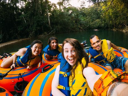 Four friends tubing down a river in Costa Rica.