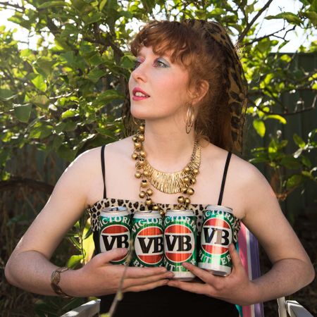 A girl holding cans of a local Australian beer.