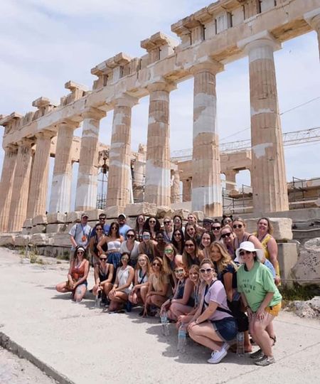 Group of sorority women posing at the Parthenon in Athens, Greece
