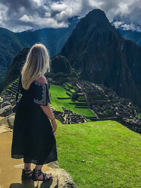 A young woman gazing into the distance at Machu Picchu.