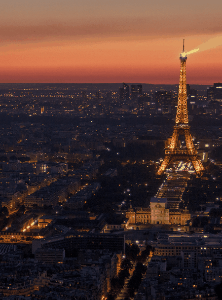 The Eiffel Tower sparkling at night.