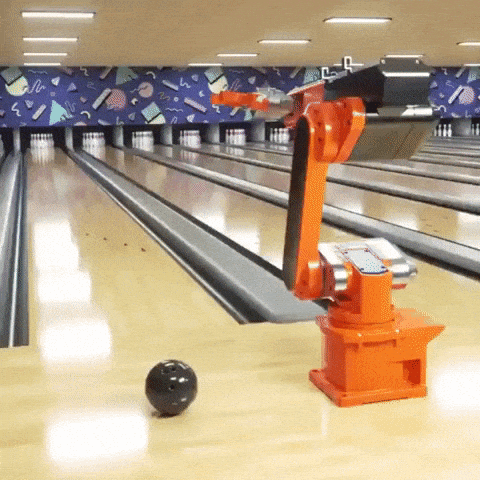 A gif of an automated machine arm throwing a bowling ball at pins