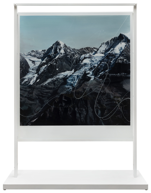 A painting of snow-capped mountains with a white thin, curling line drawn across them, raised on a white platform