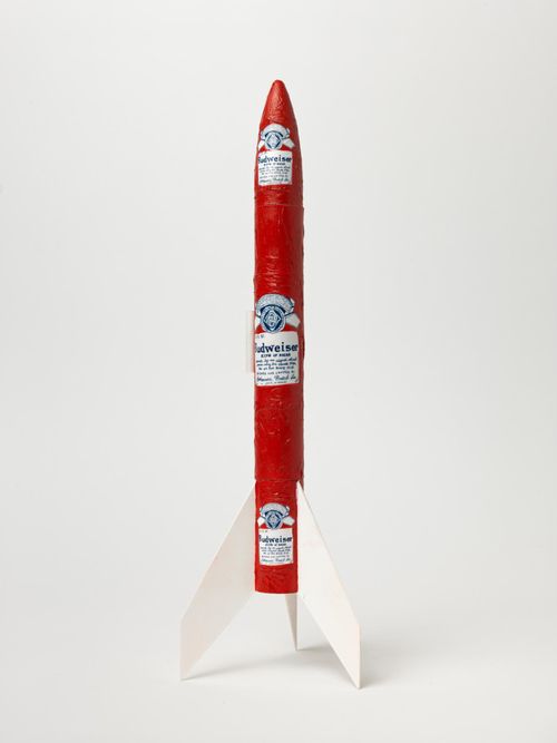 Long, thin rocket with a red body embossed with Budweiser logos