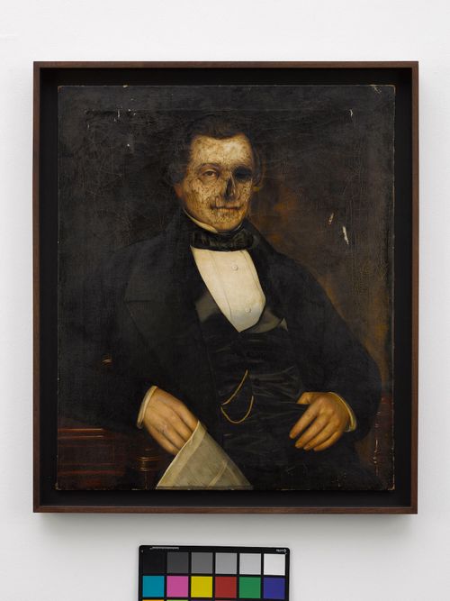 A portrait painting of a smartly dressed male whose face is decaying and transforming into that of a skeleton