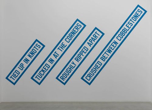 Lawrence Weiner's work displayed in a gallery