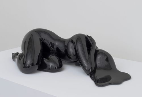 Black sculpture of a woman lying down