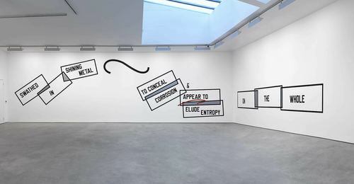 Weiner's work displayed on two white walls