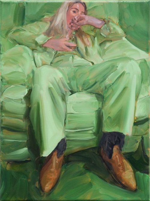 Woman reclines in green chair