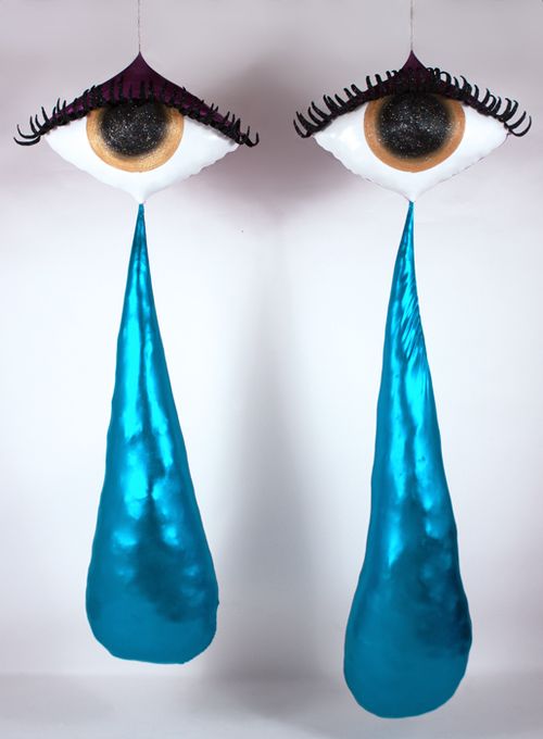 Sculpture of two large eyes with long tear drops falling from them