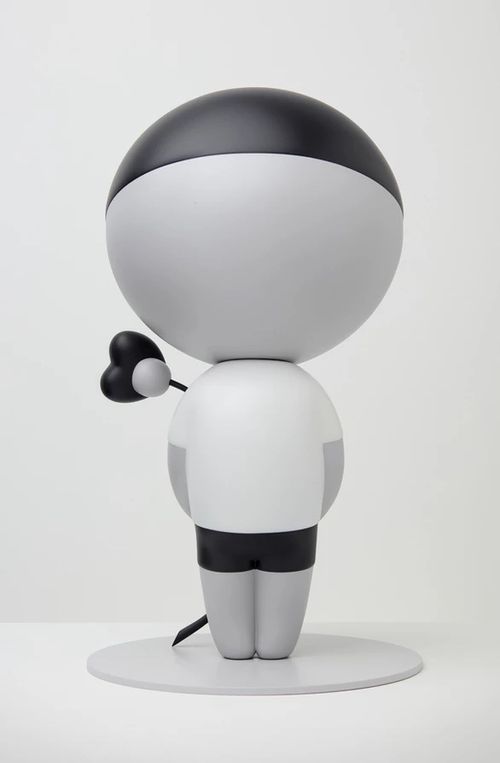 Monochrome figure of a boy without any features or details other than a black hairline, black shorts and a white t-shirt, holding a flower behind his back