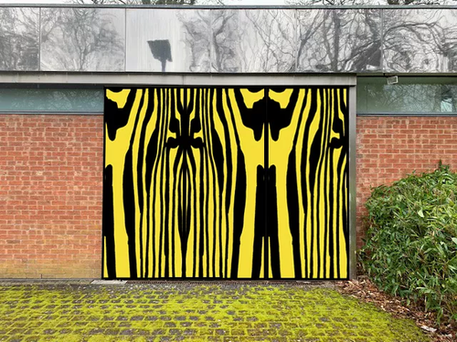 Large yellow and black work displayed on a brick wall