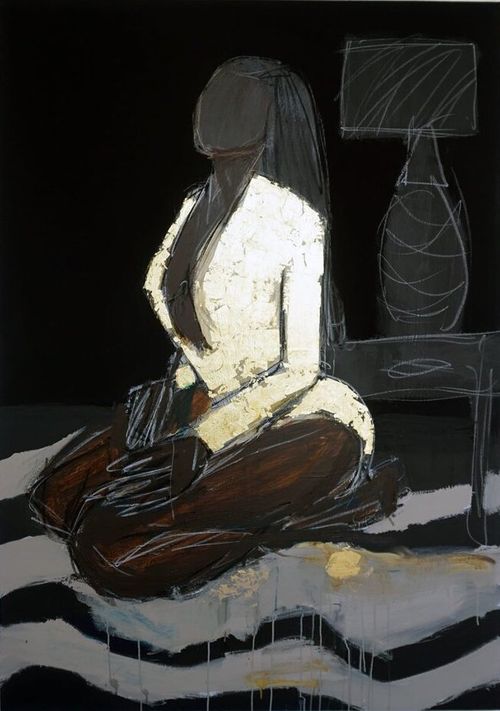 black woman in gold dress kneels on ground with outline of lamp on table behind her