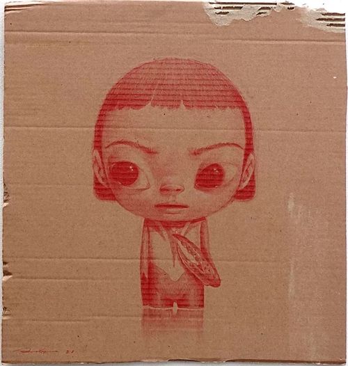 red drawing of a child on brown cardboard