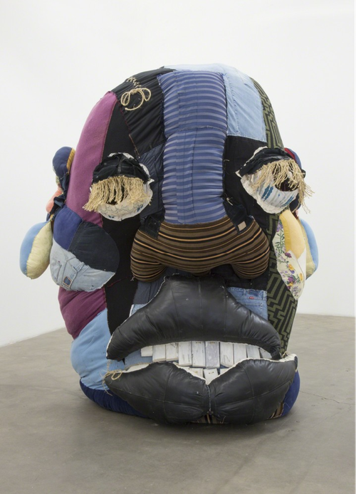 giant patchwork head with various different solid colours or striped patterns making up different areas of the face or features