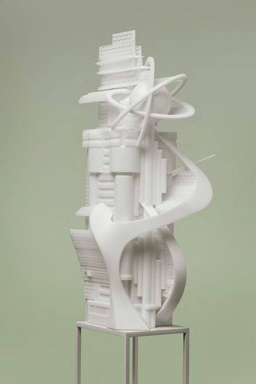 three-dimensional white architectural model of a tall, futuristic building