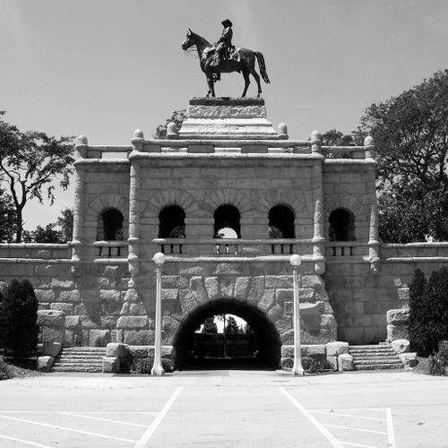 The Grant monument towers over the south pond of Lincoln Park by virtue of the two story architectural base made of massive, rusticated limestone blocks. Atop this impressive base is the huge, but placid horse upon which Grant’s figure sits. Since the figure of Grant is seen primarily from below, one has to move well away from it to fully take in its contours.