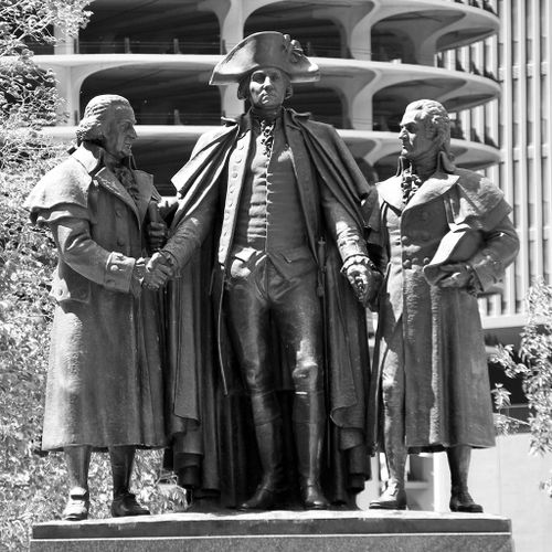 Dressed in impressively detailed and complete 18th-century attire, the three figures of Morris, Washington and Salomon stand atop a large pedestal on Wacker Drive near the Wabash Avenue Bridge. Washington faces forward and towers over Morris and Solomon, who turn to grasp the general’s right and left hands in friendship and support.