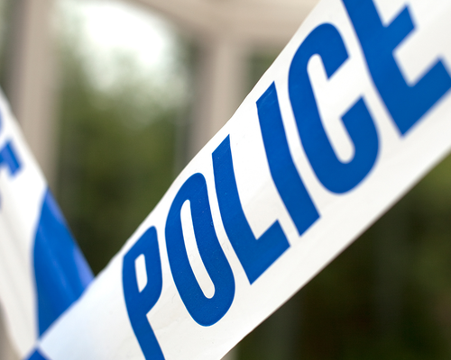 Close-up of blue and white police tape with the word 