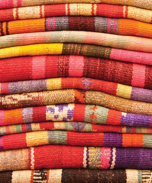 stack of woven peruvian colored blankets peru