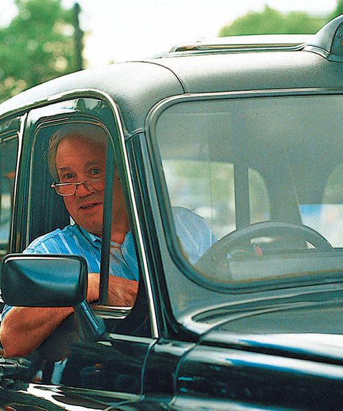 english taxi driver with arm resting out window