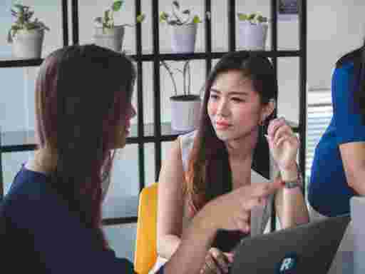 Two colleagues in a focused one-to-one coaching session