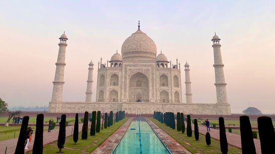 the taj mahal and the reflecting pool in front of it at sunset