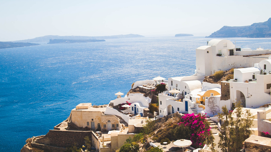 views of the aegean sea from the greek islands with white buildings in the foreground 