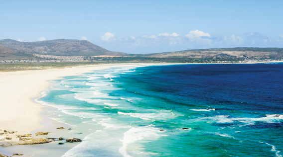 blue ocean waves crashing on the sand along the coast of south africa