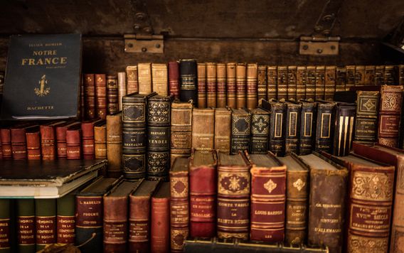 antique books stacked on a shelf