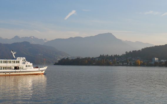big white boat cruising on lake Lucerne in Switzerland