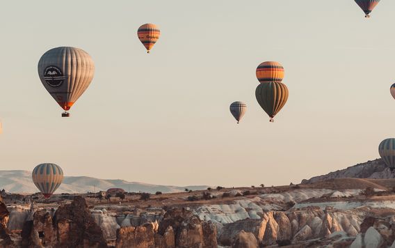 hot air balloons floating in the air at sunset in cappadocia turkey