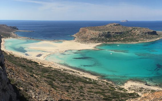 rocky cliff surrounding beach in crete greece