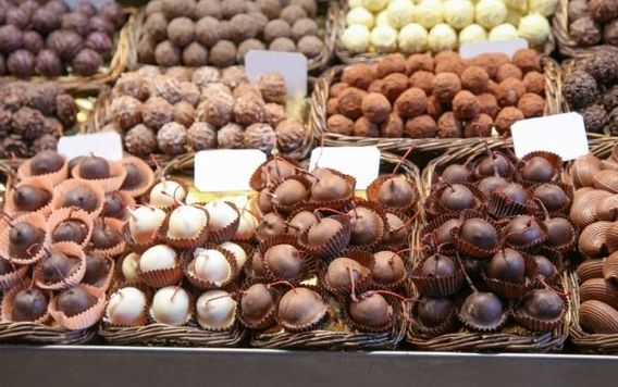 variety of chocolate covered cherries in baskets at a market