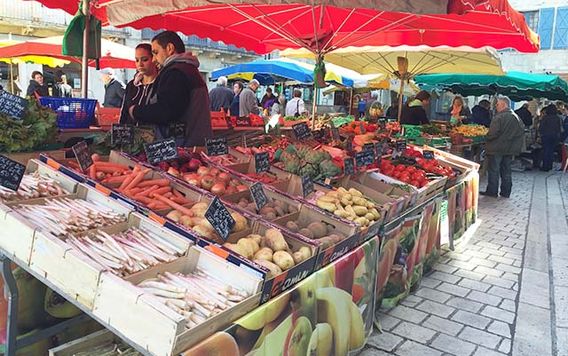 people shopping at outdoor market in perigueux france