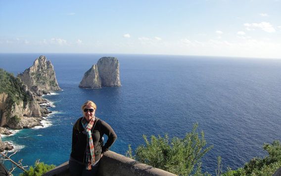 traveler standing on cliffs along the Amalfi Coast in Italy